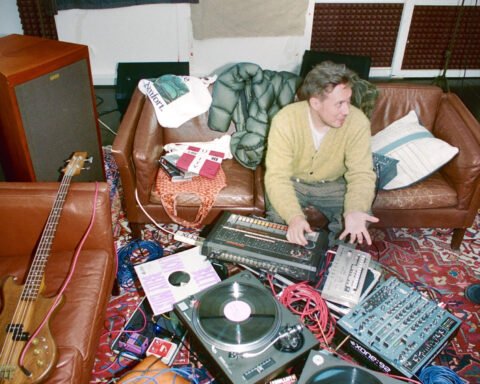 Producer Joy Orbison sits among a room of recording equipment