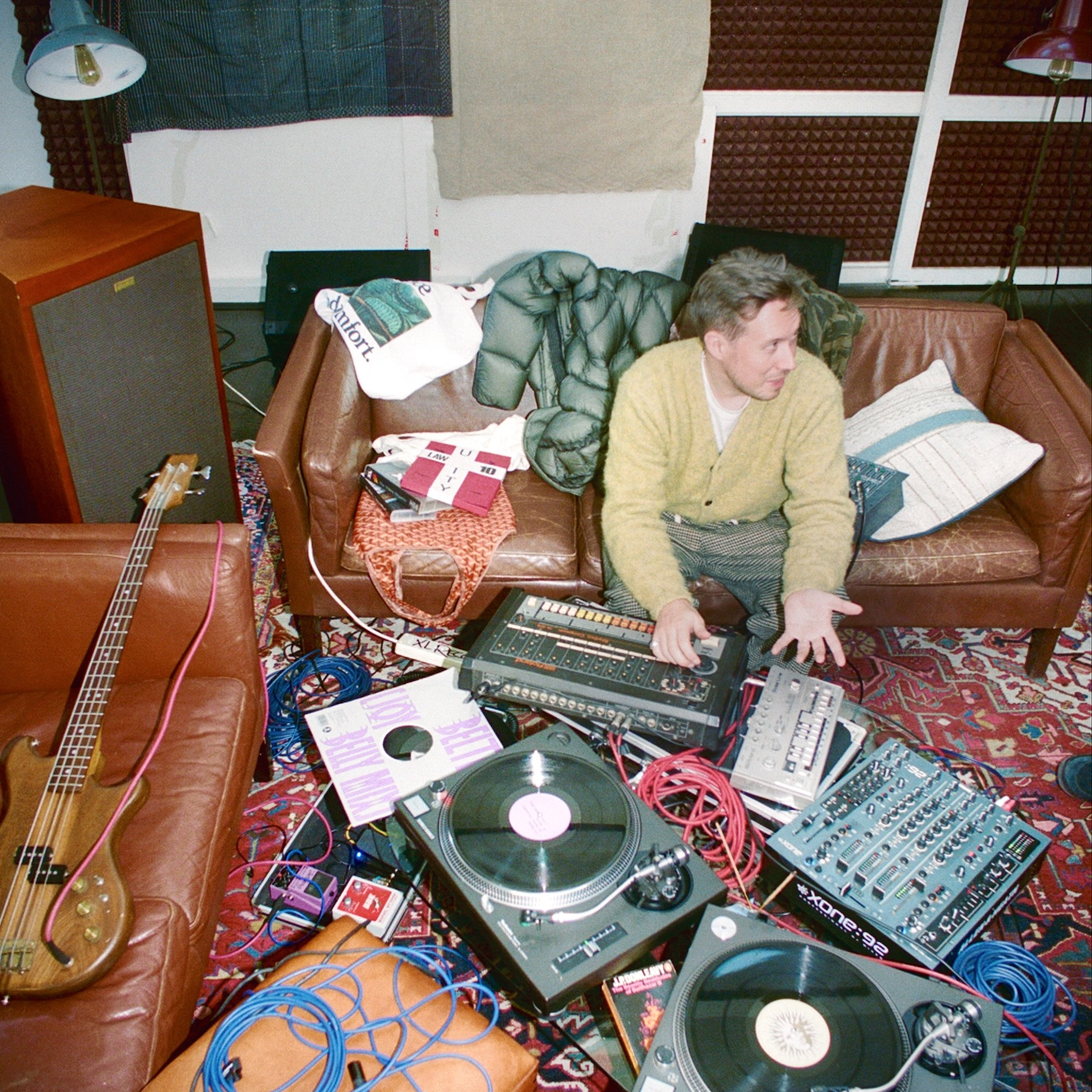 Producer Joy Orbison sits among a room of recording equipment
