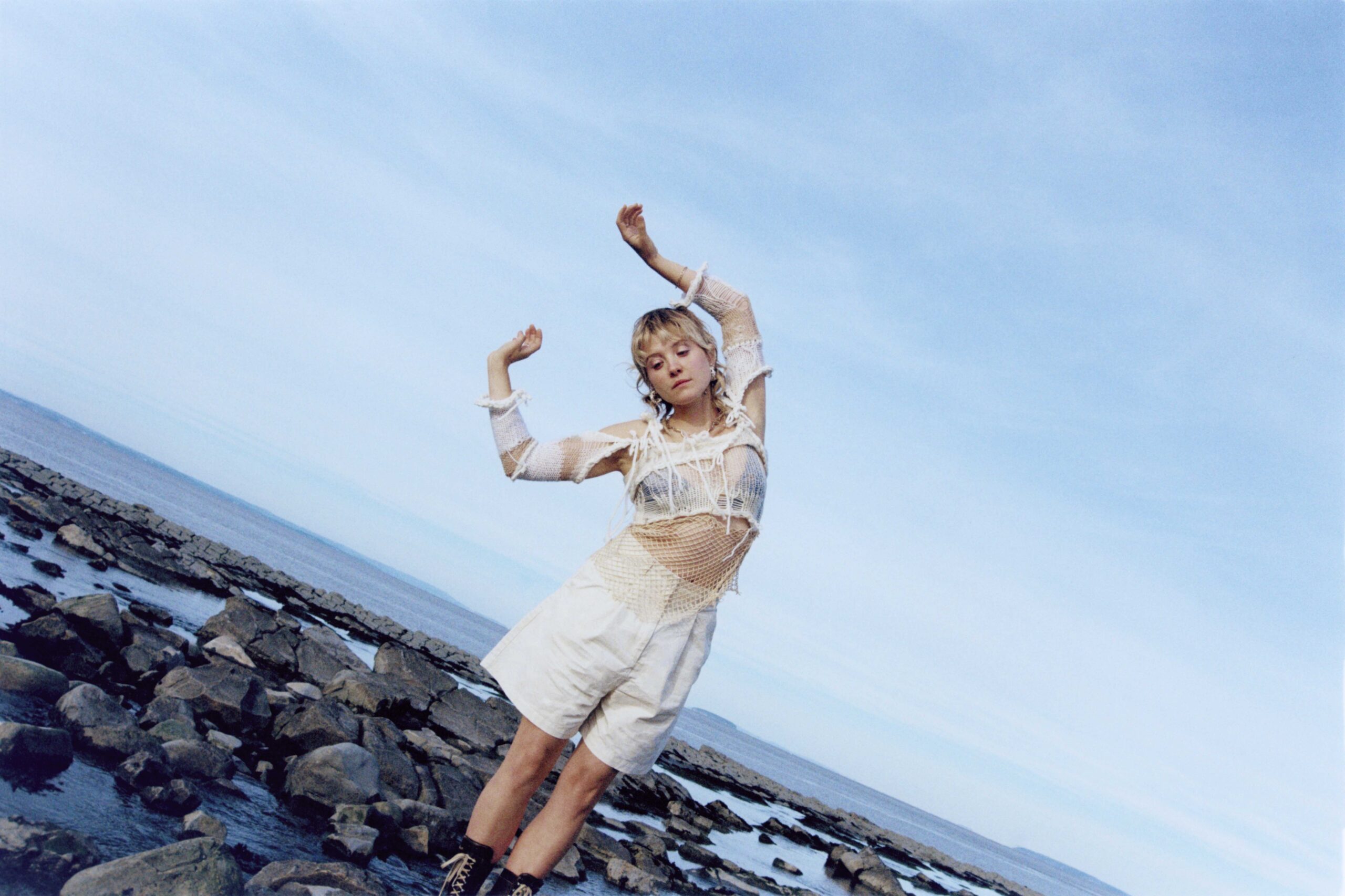 Songwriter Pem in front of blue sky