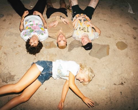 Amyl and The Sniffers promotional photo on a beach