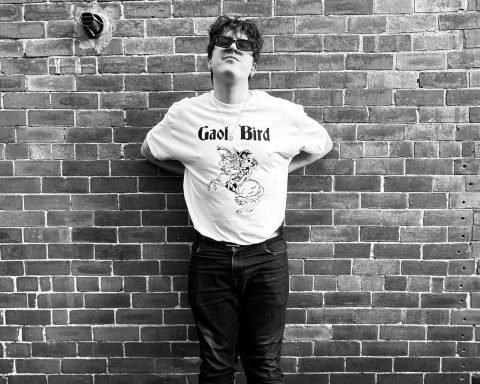 B&W image of Gaol Bird in front of a brick wall