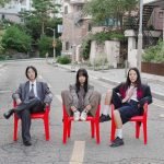 Korean punk band Sailor Honeymoon sitting on red chairs