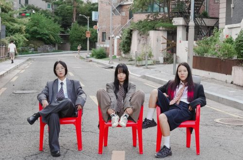 Korean punk band Sailor Honeymoon sitting on red chairs
