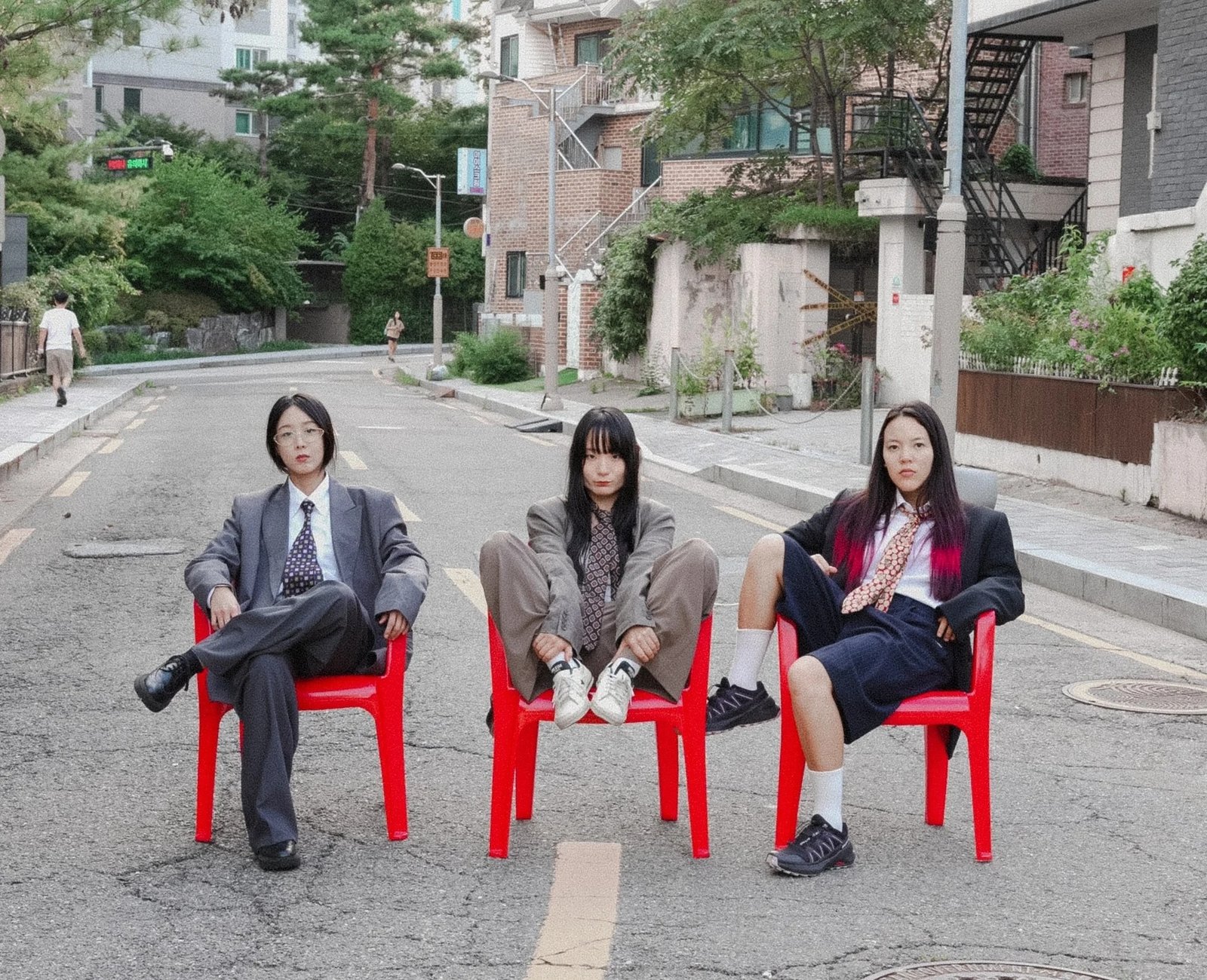 Korean punk band Sailor Honeymoon sitting on red chairs
