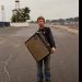 songwriter Greg Freeman holding an amplifier